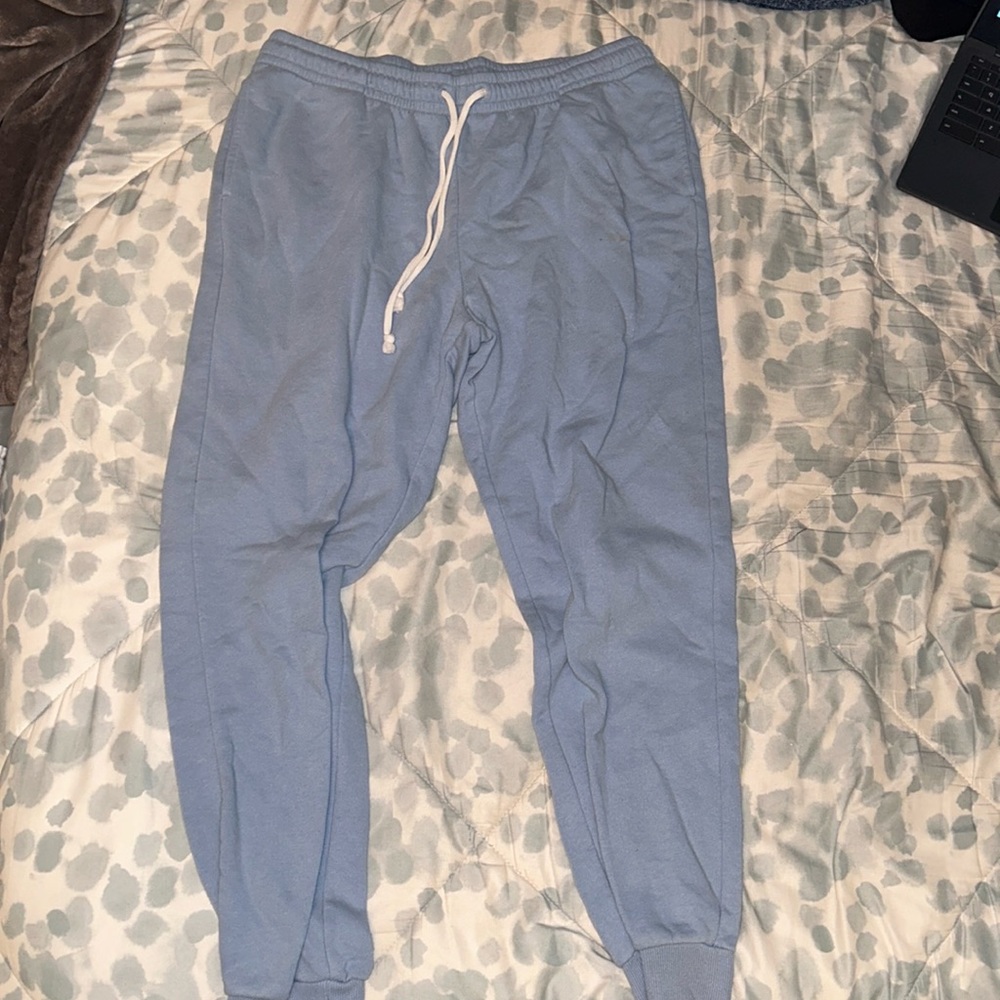 blue joggers with cuffed bottoms